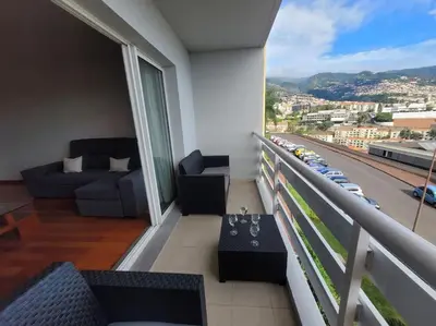 a balcony with couches and a view of a city at Pilar Balconies in Funchal City in Funchal