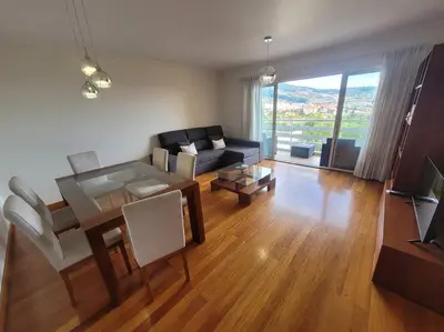 a living room with a couch and a table at Pilar Balconies in Funchal City in Funchal