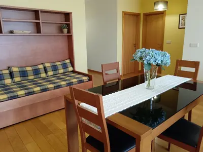 a living room with a table and a couch at Casa da Vila in Santa Cruz
