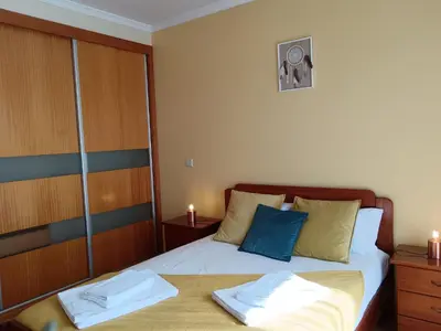 a bedroom with a bed with two towels on it at Casa da Vila in Santa Cruz
