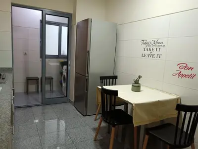 a dining room with a table and a refrigerator at Casa da Vila in Santa Cruz