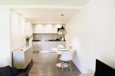 a kitchen with white cabinets and a table and chairs at GuestReady - A brilliant stay near the sea in Funchal