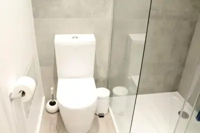 a white bathroom with a toilet and a shower at GuestReady - A brilliant stay near the sea in Funchal
