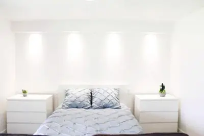 a bedroom with a bed with two white night stands at GuestReady - A brilliant stay near the sea in Funchal