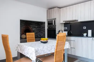 a kitchen with a table and chairs and a kitchen with a fireplace at GuestReady - Leme Beach Breathtaking Views in Gaula