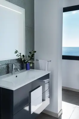 a bathroom with a white sink and a mirror at GuestReady - Leme Beach Breathtaking Views in Gaula