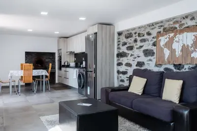 a living room with a couch and a table and a kitchen at GuestReady - Leme Beach Breathtaking Views in Gaula