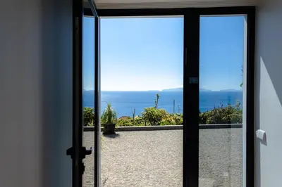 a door to a balcony with a view of the ocean at GuestReady - Leme Beach Breathtaking Views in Gaula