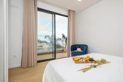 a room with a bed with a bowl of fruit on it at Stunning view set in nature - Recanto of the sea in Ponta do Sol