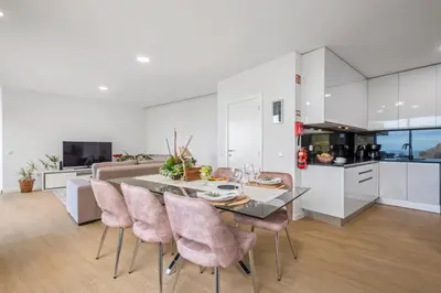 a kitchen and dining room with a table and chairs at Stunning view set in nature - Recanto of the sea in Ponta do Sol