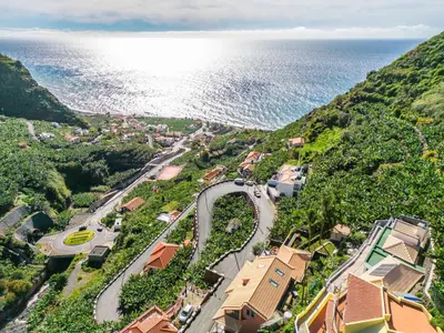 an aerial view of a town next to the ocean at Stunning view set in nature - Recanto of the sea in Ponta do Sol