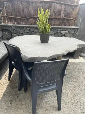a table and chairs with a potted plant on it at Cozy chalet with ocean view in Seixal