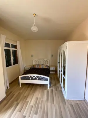 a bedroom with a bed and a wooden floor at Maria Holiday House in São Jorge