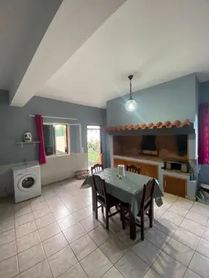 a kitchen and dining room with a table and chairs at Maria Holiday House in São Jorge