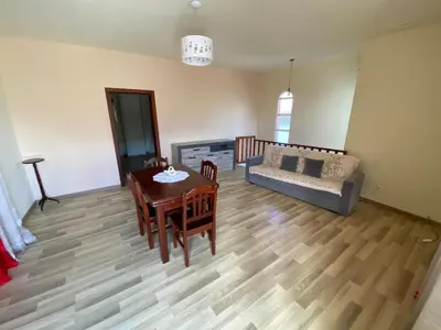 a living room with a table and a couch at Maria Holiday House in São Jorge