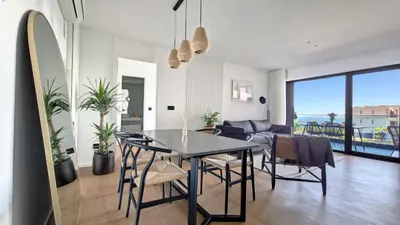 a dining room and living room with a table and chairs at Roots Loft by LovelyStay in Funchal