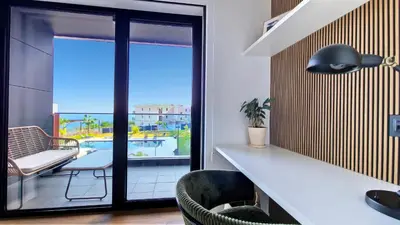 a room with a table and chairs and a balcony at Roots Loft by LovelyStay in Funchal