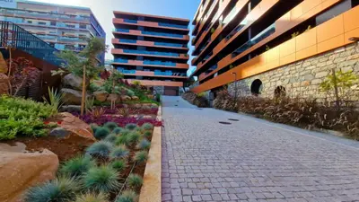 a brick walkway between two tall buildings with plants at Roots Loft by LovelyStay in Funchal