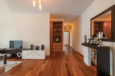 a living room with a hardwood floor and white walls at Freitas House by Homie in Ponta do Sol