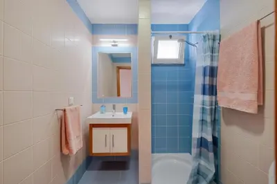 a bathroom with a toilet and a sink and a shower at Freitas House by Homie in Ponta do Sol
