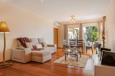 a living room with a white couch and a table at Freitas House by Homie in Ponta do Sol