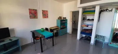 a room with a desk and a table and a shelf at Sunrise View in Funchal