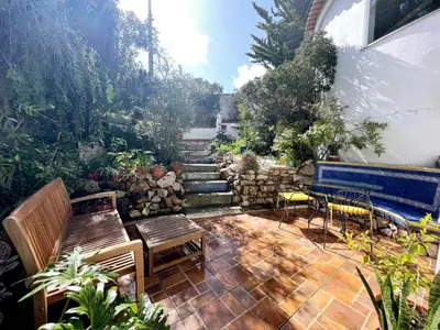 a patio with two benches and a set of stairs at Casa das Escadinhas in Budens
