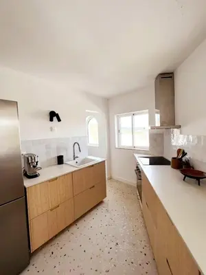 a kitchen with a sink and a refrigerator at Casa das Escadinhas in Budens