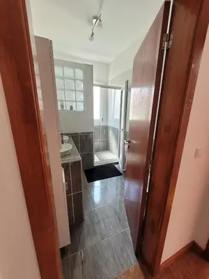 a bathroom with a toilet and a sink and a door at Maison avec vue exceptionnelle sur l'océan - 5 mn du centre ville in Santa Cruz