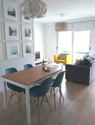 a living room with a dining room table and chairs at Berna Apartment in Funchal