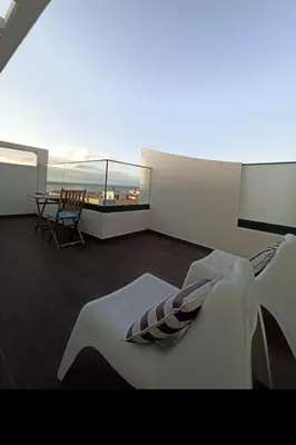 a room with a bed and a balcony with a table at Berna Apartment in Funchal