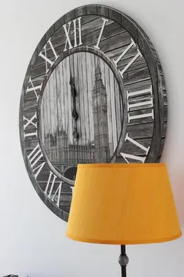 a clock hanging on a wall next to a lamp at Berna Apartment in Funchal