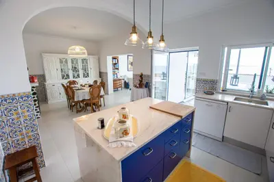 a kitchen with a island in the middle of a room at Vila Fortaleza in Aljezur