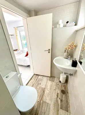 a bathroom with a toilet and a sink at Vila Fortaleza in Aljezur