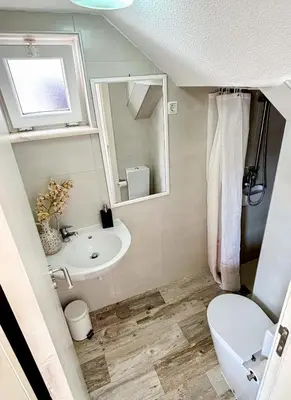 a bathroom with a sink and a toilet and a mirror at Vila Fortaleza in Aljezur