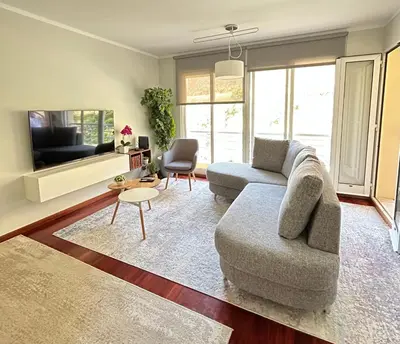 a living room with a couch and a tv at Praia Formosa Ocean View - Funchal in Funchal