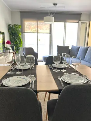 a dining room table with wine glasses on it at Praia Formosa Ocean View - Funchal in Funchal