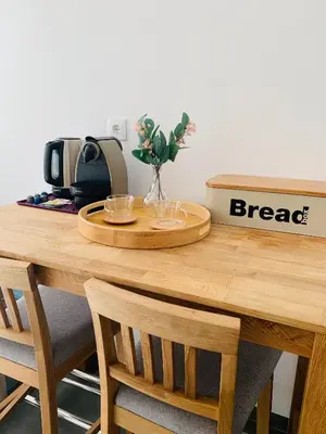 a wooden table with a coffee maker and flowers on it at Praia Formosa Ocean View - Funchal in Funchal