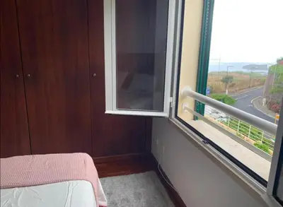 a room with a window with a view of a street at Praia Formosa Ocean View - Funchal in Funchal