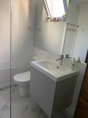 a white bathroom with a sink and a toilet at Praia Formosa Ocean View - Funchal in Funchal