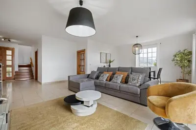 a living room with a couch and a table at Sunny House by Homie in Canhas