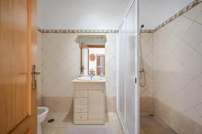 a bathroom with a sink and a shower at Sunny House by Homie in Canhas