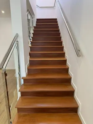 a staircase with wooden treads in a home with white walls at C - Charming Vacation home with FREE Private Parking in Machico