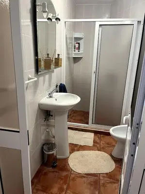a bathroom with a sink and a toilet at Kleines Haus am Meer in Arco da Calheta