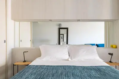 a bedroom with a large bed with white pillows at Marina Club Studio Apartment in Funchal