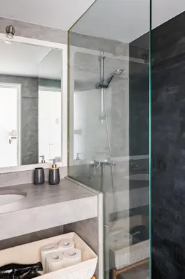 a bathroom with a shower and a sink at Marina Club Studio Apartment in Funchal