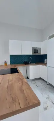 a kitchen with a wooden counter top in a room at Seven in Funchal
