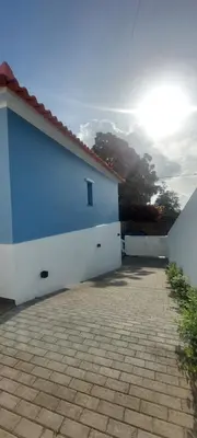 a blue and white building with a brick driveway at Seven in Funchal