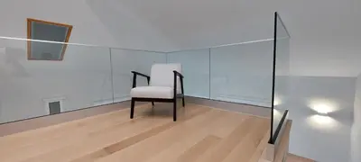 a chair in a room with a glass wall at Seven in Funchal