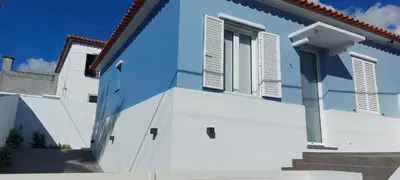 a blue and white house with a door and window at Seven in Funchal
